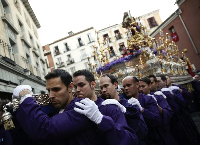 Costaleros (men who carry floats bearing the statue of Christ or the Virgin) carry the float of the “Jesus el Pobre” brotherhood during a procession at Holy Week in Madrid, Spain, March 24, 2016. (Photo by Andrea Comas/Reuters)