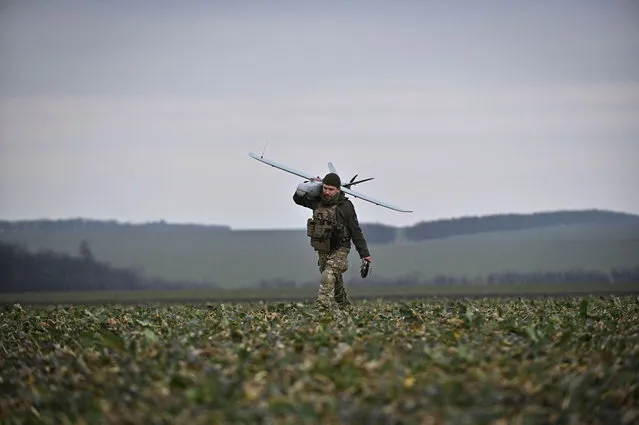 A Ukrainian serviceman carries a Leleka reconnaissance unmanned aerial vehicle (UAV) after it flew at a front line, amid Russia's attack on Ukraine, in Zaporizhzhia region, Ukraine on February 15, 2024. (Photo by Reuters/Stringer)