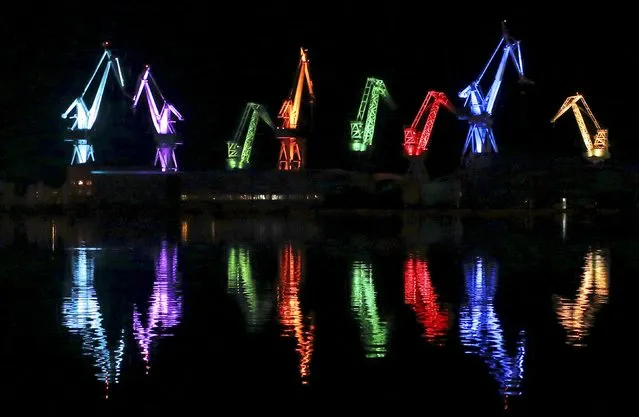 The cranes of Uljanik shipyard are painted with light during Visualia Festival in the Adriatic town of Pula, Croatia May 8, 2015. Visualia Festival is a festival of audio-visual art with the objective of modernizing and approaching new technologies to citizens. (Photo by Antonio Bronic/Reuters)