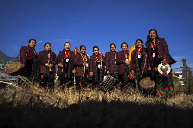 Band members of Shrijanshil Mahila Sanstha, or the Self-Reliant Women’s Group, stand for a photograph before they prepare to play at a wedding in Kathmandu, Nepal, Wednesday, March 6, 2024. Once associated only with men from the Damai community, part of the lowest caste, these nine women have come together to play the naumati baja, or nine traditional instruments. Discrimination based on caste is believed to have caused some Dalit musicians to quit playing naumati baja. (Photo by Niranjan Shrestha/AP Photo)