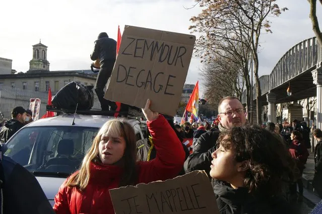 A protester holds a placard reading “Zemmour get out” during a demonstration against French presidential candidate Eric Zemmour, Sunday, December 5, 2021 in Paris. French far right presidential candidate Eric Zemmour holds his first campaign rally in Villepinte, north of Paris. A first round is to be held on April, 10, 2022 and should no candidate win a majority of the vote in the first round, a runoff will be held between the top two candidates on April 24, 2022. (Photo by Michel Spingler/AP Photo)