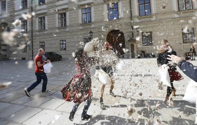 People fight with pillows during World Pillow Fight Day in Vienna, Austria, April 2, 2016. (Photo by Leonhard Foeger/Reuters)