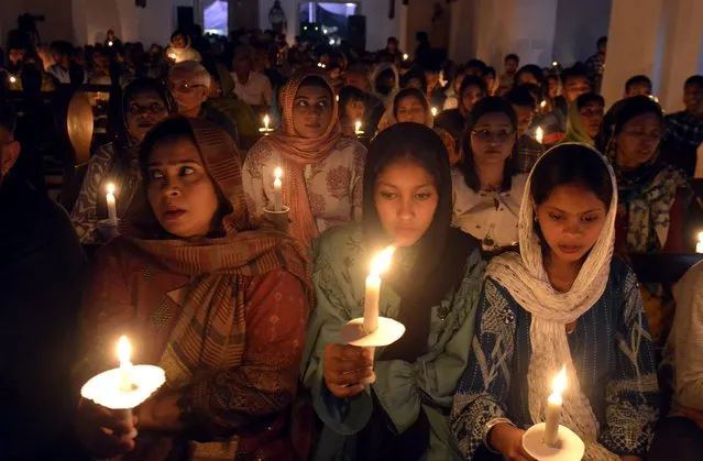 Members of the Christian minority community hold candles at a church on Easter Sunday, at Church in Rawalpindi, Pakistan, 31 March 2024. Christians, about 1.6 percent of Pakistan's population, are the second largest religious minority in Pakistan after Hindus. Easter Sunday is one of the major religious holidays observed by Christians around the world, commemorating the resurrection of Jesus Christ. (Photo by Sohail Shahzad/EPA/EFE/Rex Features/Shutterstock)