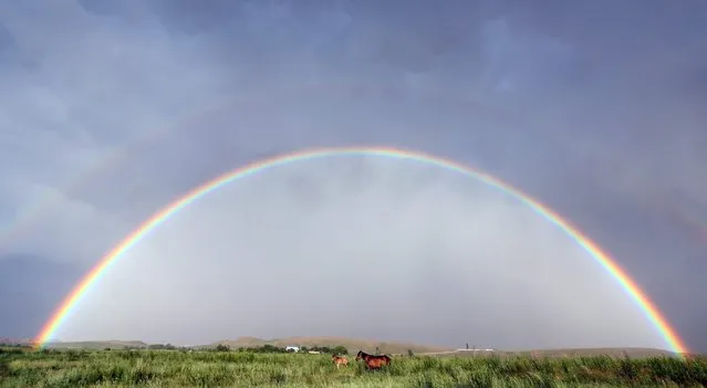 A view ofa rainbow near the village Bokonbaevo, 270 km from Bishkek, Kyrgyzstan, 22 June 2016. (Photo by Igor Kovalenko/EPA)