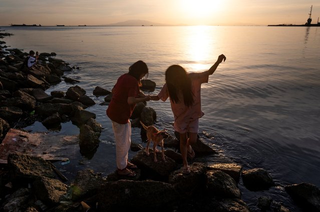 Children play near Manila bay during a hot day, in Manila, Philippines, on April 8, 2024. (Photo by Lisa Marie David/Reuters)