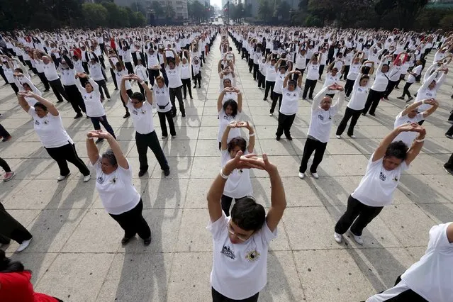 People practice Taichi during a mass class at Revolucion monument in Mexico City, Mexico, April 23, 2016. (Photo by Edgard Garrido/Reuters)