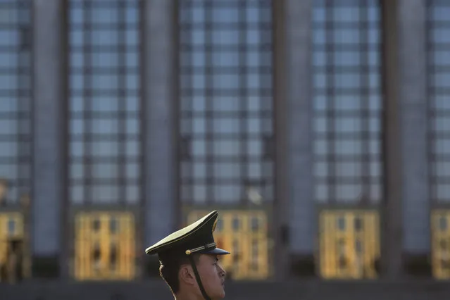 In this Wednesday, March 8, 2017 photo, a Chinese paramilitary policeman stands on duty in front of the Great Hall of the People in Beijing, China. While the Great Hall of the People buzzes with activity during state events, especially the roughly two-weeks of the legislative session, at other times the hall is strangely quiet, with voices echoing off its marble walls and sentinels standing silently in its forecourt that looks out onto the vast expanse of Tiananmen Square. (Photo by Ng Han Guan/AP Photo)