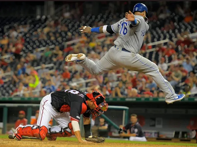 Kansas City Royals’ Martin Maldonado, right, vaults over Nationals catcher Kurt Suzuki after scoring a run in the 11th inning during their baseball game at Nationals Park in Washington, D.C. on July 5, 2019. (Photo by John McDonnell/The Washington Post)