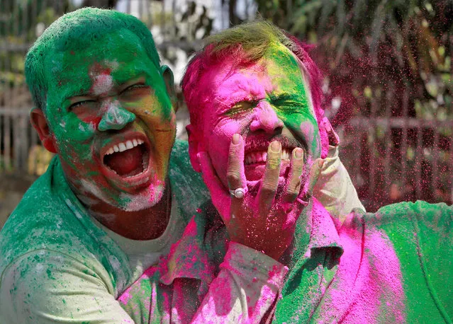 Men, whose faces are smeared with coloured powders, react as they celebrate Holi, the Festival of Colours, in Agartala, India March 13, 2017. (Photo by Jayanta Dey/Reuters)