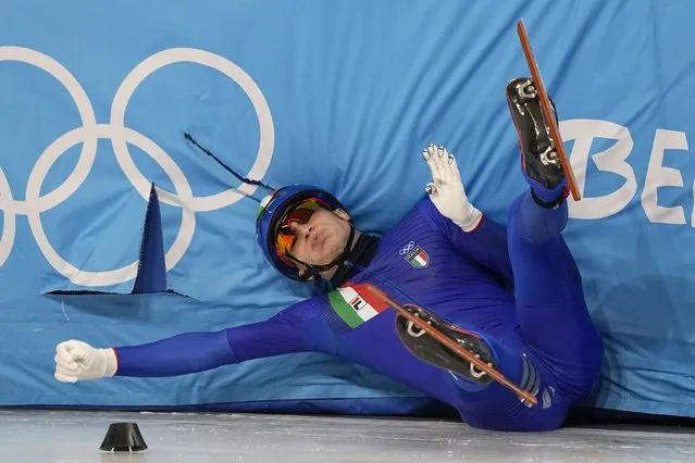 Pietro Sighel of Italy crashes during his heat of the men's 1,000-meter during the short track speedskating competition at the 2022 Winter Olympics, Saturday, February 5, 2022, in Beijing. (Photo by David J. Phillip/AP Photo)