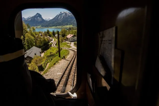 A picture made available on 02 May 2016 shows the Wolfgangsee Lake through the window of an oil-fired steam locomotive of the SchafbergBahn cogwheel railway near St. Wolfgang im Salzkammergut, some 285 kilometers southwest of Vienna, Austria, on 30 April 2016. The SchafbergBahn, with a maximum gradient of max 26 percent, is the steepest cogwheel railway in Austria, operating from April to October. Six coal-fired steam locomotives (since 1893), four oil-fired steam locomotives (since 1992) and one vintage diesel railcar pass the 5.8 kilometers long track leading up to the Schafbergspitze at 1,732 meters (5,682 ft) above sea level. (Photo by Christian Bruna/EPA)
