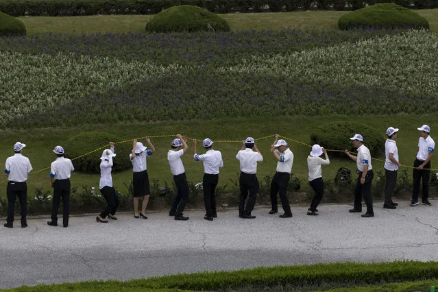Staff members stand along a restricted area during the ceremony marking the 74th anniversary of the atomic bombing of Hiroshima at the Hiroshima Peace Memorial Park on August 6, 2019 in Hiroshima, Japan. Japan marks the 74th anniversary of the first atomic bomb that was dropped by the United States on Hiroshima on August 6, 1945. The bomb instantly killed an estimated 70,000 people and thousands more in coming years from radiation effects. Three days later the United States dropped a second atomic bomb on Nagasaki which ended World War II. According to media reports, Pope Francis plans to visit Hiroshima and Nagasaki later this year during his four-day stay in Japan in November to offer prayers for victims of the atomic bombings. (Photo by Tomohiro Ohsumi/Getty Images)