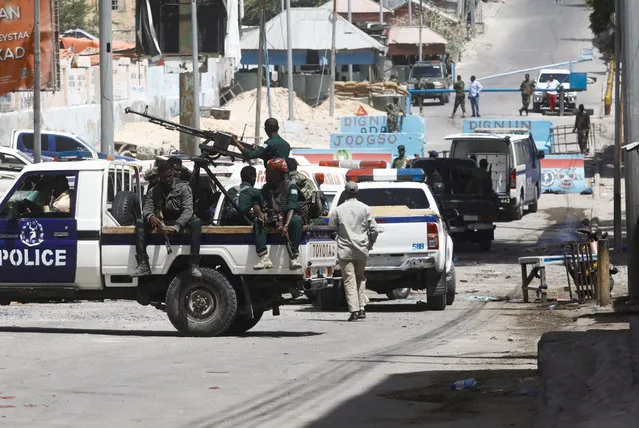 Somali security secure the road leading to the scene of an explosion at a checkpoint near the Presidential palace in Mogadishu, Somalia, February 10, 2022. (Photo by Feisal Omar/Reuters)