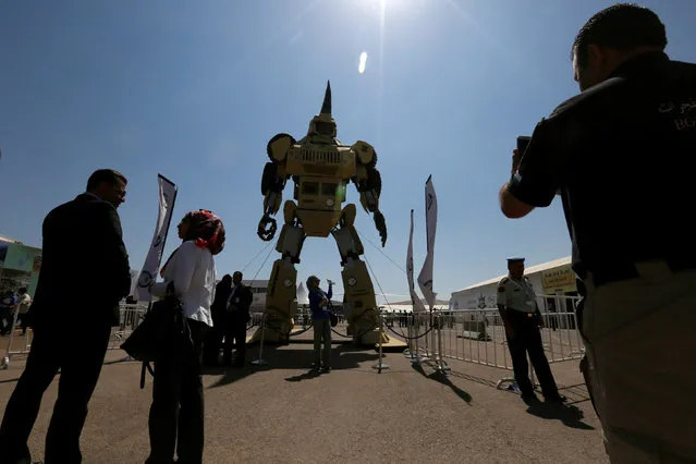 Visitors take a pictures with a giant robot during the second day of the second day of the Special Operations Forces Exhibition (SOFEX) at King Abdullah II Airbase in Amman, Jordan, May 11, 2016. (Photo by Muhammad Hamed/Reuters)