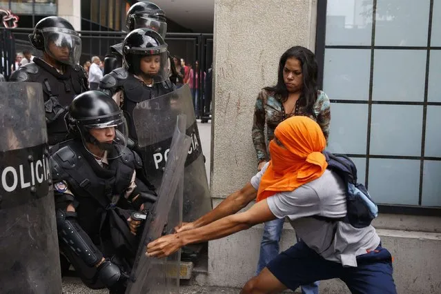 National Guard personnel in riot gear struggle with anti-government demonstrators during a protest in Caracas on May 12, 2014. (Photo by Carlos Garcia Rawlins/Reuters)