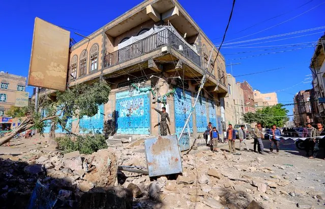 Yemenis inspect damage following a reported overnight air strike by the Saudi-led coalition targeting in the Huthi rebel-held capital Sanaa, on December 24, 2021. (Photo by Mohammed Huwais/AFP Photo)