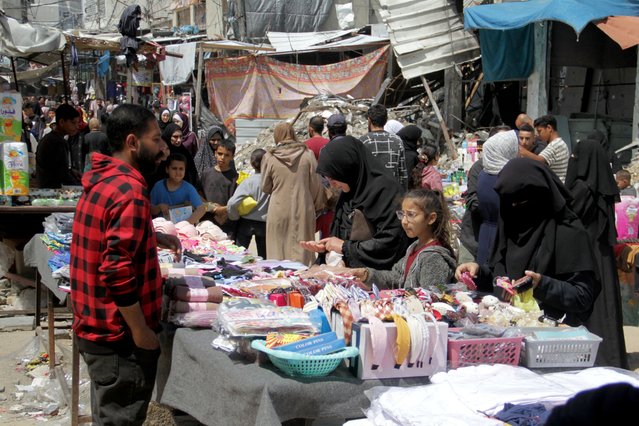 Palestinians shop as they prepare for the upcoming holiday of Eid al-Fitr in northern Gaza Strip, on April 9, 2024. (Photo by Mahmoud Issa/Reuters)