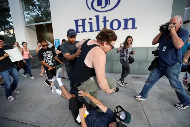 A supporter (C) of Republican U.S. presidential candidate Donald Trump collides with another man after he was confronted by demonstrators outside a campaign rally in San Jose, California, U.S. June 2, 2016. (Photo by Stephen Lam/Reuters)