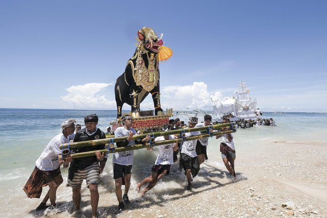 The Hindus of Nusa Penida, Bali, Indonesia, carry out their annual Ngaben cremation on April 4, 2022, when they place the bones of those who have died over the past year on to floating animal forms in a ceremony that is said to release the souls of the deceased. (Photo by Gede Sudika/Solent News/Rex Features/Shutterstock)
