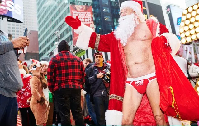 People dressed as Santa Claus gather at Father Duffy Square for SantaCon on December 14, 2019 in New York City. Every year, people dress up as Santa Claus or in other holiday-themed costumes, and drink at multiple bars across the city. (Photo by Gabby Jones/Getty Images)