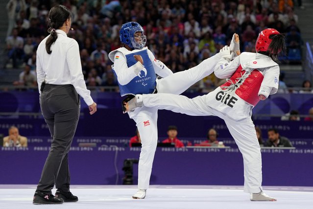 Patricia Kyeremaa of Ghana (left) aims a kick but faces one herself from Greece’s Eleni Papastamatopoulou in the last 16 of the women’s K44 +65kg taekwondo competition on August 31, 2024. (Photo by Maja Smiejkowska/Reuters)