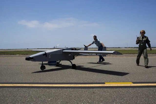 The Navmar Applied Sciences Corp. TigerShark is escorted off the runway after landing during “Black Dart”, a live-fly, live fire demonstration of 55 unmanned aerial vehicles, or drones, at Naval Base Ventura County Sea Range, Point Mugu, near Oxnard, California July 31, 2015. (Photo by Patrick T. Fallon/Reuters)