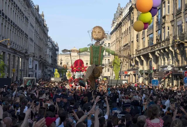 Thousands of people take part in a parade, part of the of the sixth season of Lille3000, in the streets of the northern city of Lille on May 14, 2022. (Photo by Francois Lo Presti/AFP Photo)
