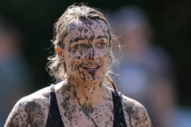 Amanda Lackey, of Bow, N.H., is splattered with mud as she walks back to the huddle during a women's football game at the  Mud Bowl in North Conway, N.H., Saturday, September 7, 2024. (Photo by Robert F. Bukaty/AP Photo)