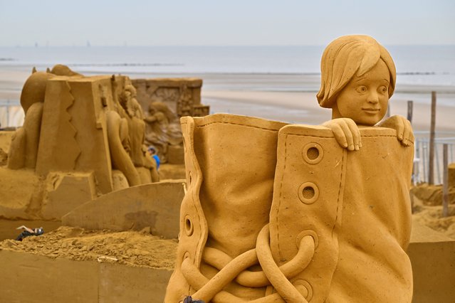 A sand sculpture representing figures in fairy tales is ready prior to the start of the Sand Sculpture Festival, in Middelkerke, Belgium on June 22, 2023. (Photo by John Thys/AFP Photo)