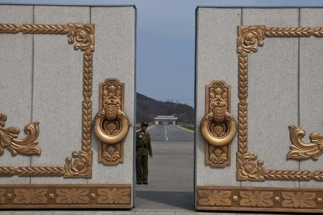 In this Monday, April 15, 2013, file photo, a North Korean soldier guarding the entrance to Pyongyang's Kumsusan mausoleum, where the bodies of the late leaders Kim Il Sung and Kim Jong Il lie embalmed, looks back through the doors of the main gate. The death last week of American student Otto Warmbier, who fell into a coma after being arrested in North Korea, has raised questions about whether his tour agency was adequately prepared for its trips into the hard-line communist state. The Young Pioneer Tours agency built up a business attracting young travelers with cut-rate, hard-partying adventures into one of the world’s most isolated countries. (Photo by David Guttenfelder/AP Photo)
