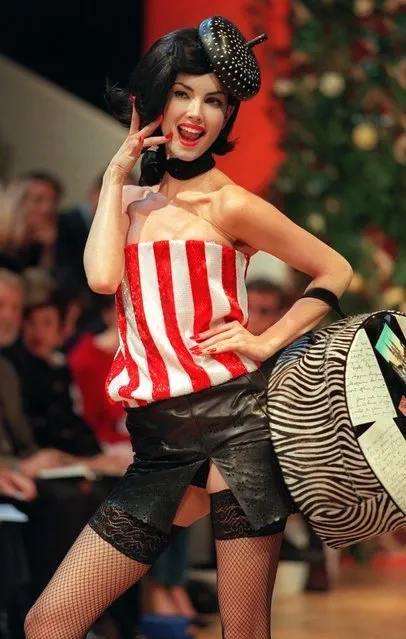 A model wears a red and white striped bustier over a black leather mini-skirt and fishnet stockings by British designer Alexander McQueen for the Givenchy 1999 Spring/Summer haute couture collection in Paris 17 January, 1999. (Photo by Eric Feferberg/AFP Photo)