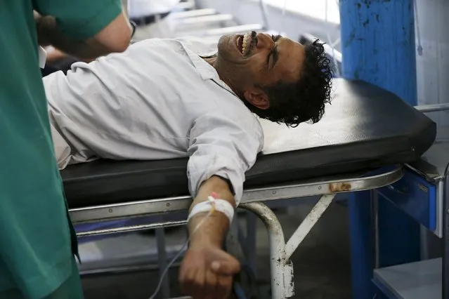 An Afghan man receives treatment at a hospital after a suicide car bomb in Kabul, Afghanistan August 10, 2015. (Photo by Omar Sobhani/Reuters)