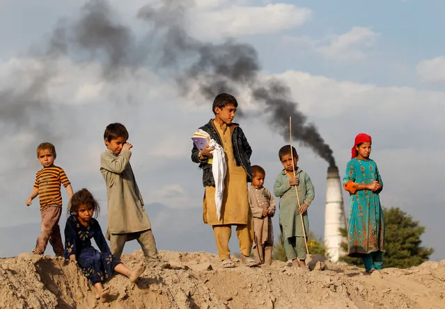 Afghan children stand at a brick-making factory on the outskirts of Jalalabad city, eastern Afghanistan on November 13, 2019. (Photo by Reuters/Parwiz)