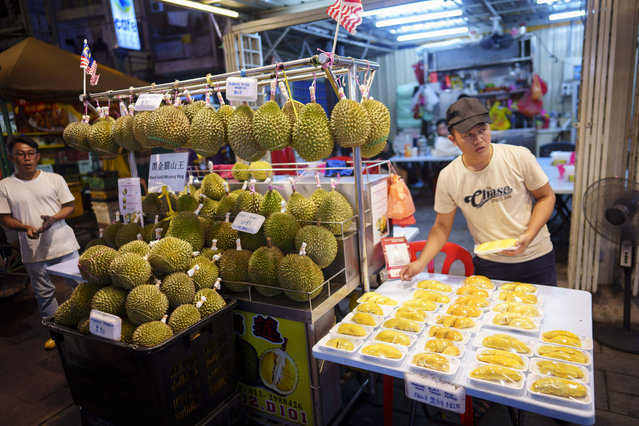 Durian vendors wait for customers in Kuala Lumpur, Monday, August 19, 2024. (Photo by Vincent Thian/AP Photo)