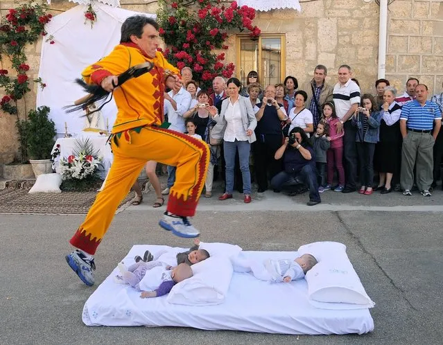 A man representing the devil leaps over babies during the festival of El Colacho in Castrillo de Murcia near Burgos, Spain