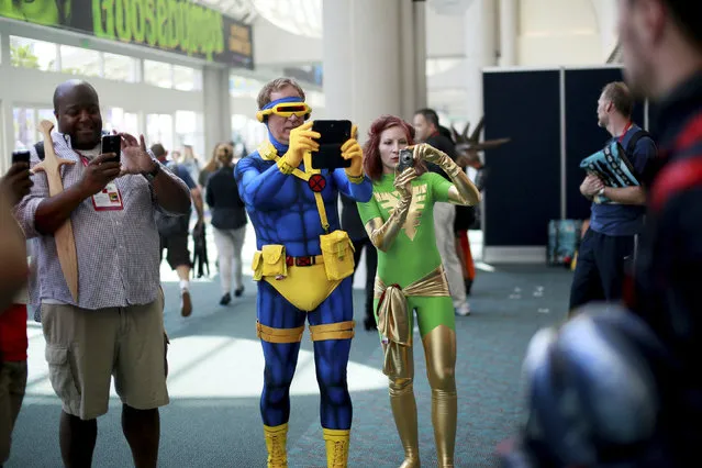 Costumed attendees take pictures during the 2014 Comic-Con International Convention in San Diego, California July 24, 2014. (Photo by Sandy Huffaker/Reuters)