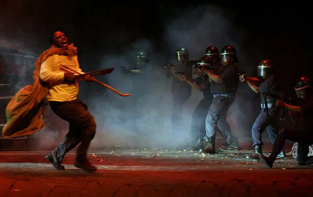 In this photo taken Thursday, Aug. 13, 2015 actors, re-enact the scene when police, right, open fire on striking platinum mineworkers, in the musical “Marikana” in Pretoria, South Africa. (Photo by Themba Hadebe/AP Photo)