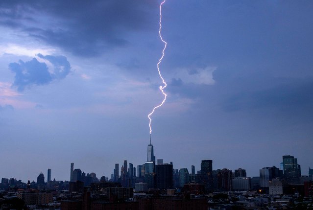 A lightning bolt strikes One World Trade Center during a thunderstorm in New York City on June 22, 2024, as seen from Jersey City, New Jersey. (Photo by Gary Hershorn/Getty Images)