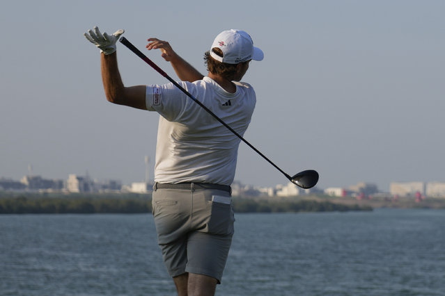 Rasmus Højgaard of Denmark loses grip of his club as he tees off at the 17th hole during the second round of Abu Dhabi Golf Championship in Abu Dhabi, United Arab Emirates, Friday, November 8, 2024. (Photo by Altaf Qadri/AP Photo)