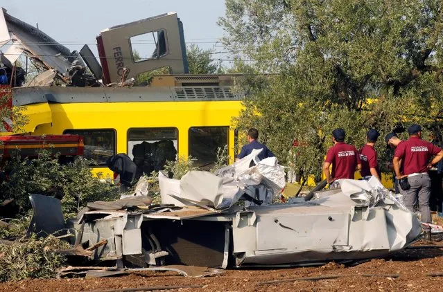 Rescuers stand at the site where two passenger trains collided in the middle of an olive grove in the southern village of Corato, near Bari, Italy, July 12, 2016. (Photo by Alessandro Garofalo/Reuters)