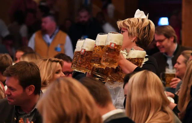 Visitors celebrate the opening of the 2017 Oktoberfest beer festival in the Schottenhamel beer tent with the first served 'Mass' (1 liter beer) on September 16, 2017 in Munich, Germany. Oktoberfest is the world's largest beer celebration and typically draws over six million visitors over its three-week run. Oktoberfest includes massive beer tents, each run by a different Bavarian brewer, as well as amusement rides and activities. (Photo by Joerg Koch/Getty Images)