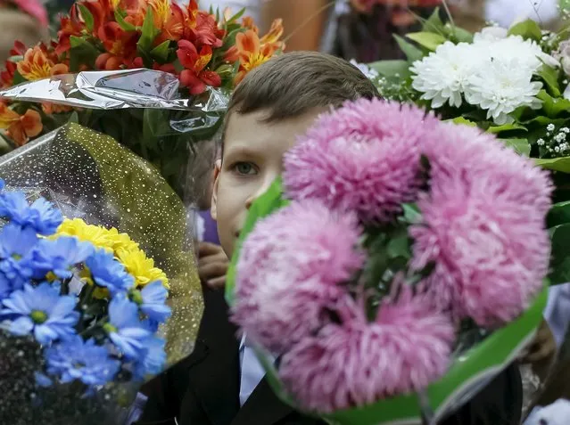 A first grader attends a ceremony to mark the start of another school year in Kiev, Ukraine, September 1, 2015. (Photo by Gleb Garanich/Reuters)
