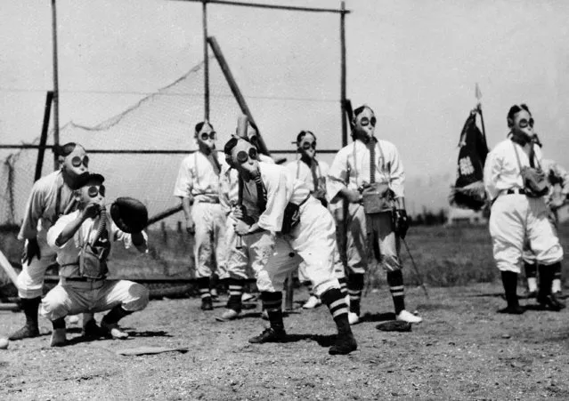 Ball players are seen playing while wearing gas masks, September 3, 1938 in a psychological and physiological experiment by the Tokyo air defense bureau. (Photo by AP Photo)