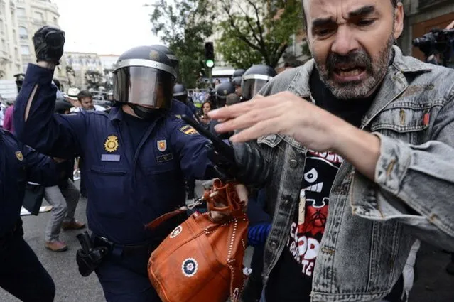 A protester clashes with riot policemen during a demonstration organized by Spain's "indignant" protesters to decry an economic crisis they say has "kidnapped" democracy, on September 25, 2012 in Madrid. Spanish riot police fired rubber bullets and baton-charged protesters as thousands rallied near parliament in Madrid in anger at the government's handling of the economic crisis.AFP PHOTO/ PIERRE-PHILIPPE MARCOU        (Photo credit should read PIERRE-PHILIPPE MARCOU/AFP/GettyImages)