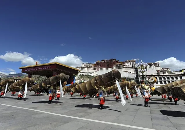 Performers dance as they march past in front of the Potala Palace during the celebration event marking the 50th anniversary of the founding of the Tibet Autonomous Region, in Lhasa, Tibet Autonomous Region, China, September 8, 2015. (Photo by Reuters/China Daily)