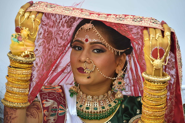 A Hindu bride attends a mass marriage ceremony in Karachi, Pakistan, 12 January 2025. Over 100 Hindu couples participated in a mass wedding ceremony organized by the Pakistan Hindu Council (PHC) on 12 January, aimed at alleviating the financial burden of wedding expenses for economically disadvantaged families. This event, part of an annual tradition established 16 years ago, involves a selection process where applicants are shortlisted based on their income and social status. (Photo by Shahzaib Akber/EPA)