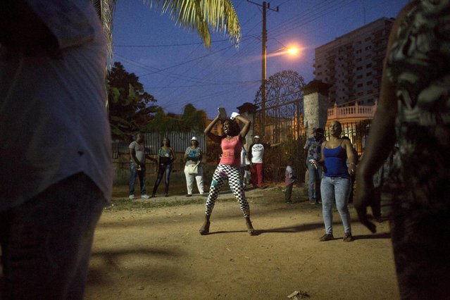 A woman reacts during the party of Yensy Villarreal, 9, (not pictured), in celebration for becoming a Santero after passing a year-long rite of passage in the Afro-Cuban religion Santeria, Havana, July 5, 2015. (Photo by Alexandre Meneghini/Reuters)