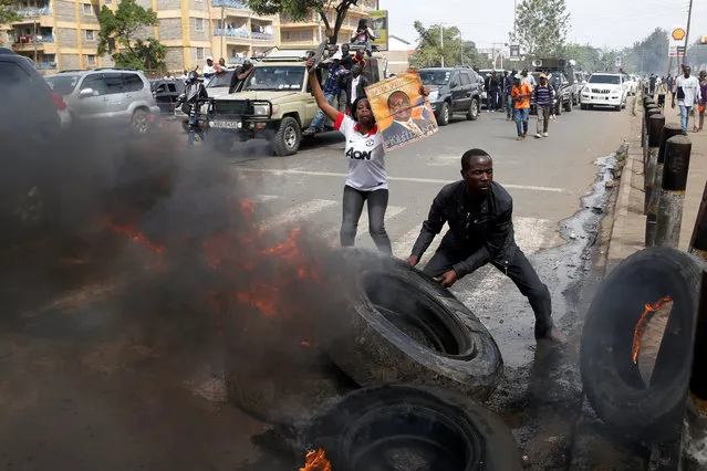 Supporters of Kenyan opposition National Super Alliance (NASA) coalition set tires on fire in Nairobi, Kenya on November 17, 2017. (Photo by Baz Ratner/Reuters)