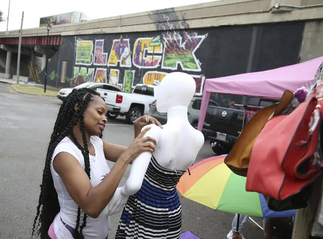 Demetria Jackson, from Kansas City, Kan,, sets out merchandise ahead of a Juneteenth celebration in the Greenwood District in Tulsa, Okla., on Friday, June 19, 2020. Friday marks Juneteenth, the day in 1865 when federal troops arrived in Galveston, Texas, to take control of the state and ensure all enslaved people be freed more than two years after the Emancipation Proclamation. (Photo by Matt Barnard/Tulsa World via AP Photo)