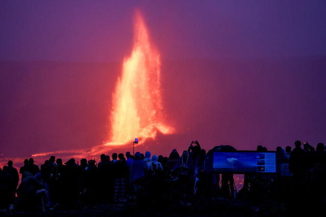 People watch as lava erupts from Halema'uma'u crater within the summit caldera Kaluapele, at the Kilauea volcano in Hawaii, U.S. March 26, 2025. (Photo by Marco Garcia/Reuters)